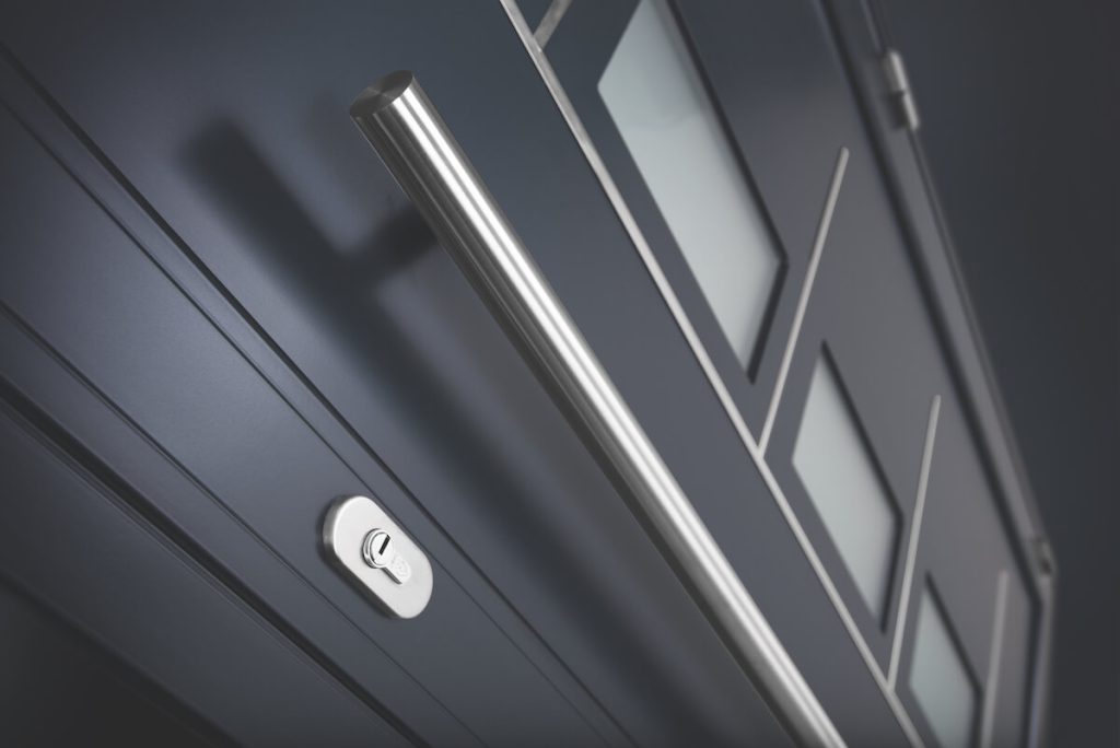 A close-up of an Origin aluminium front door handle and lock, showcasing the modern design and secure locking mechanism, ideal for homes in {location}.